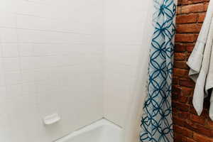 Bathroom with shower / tub combo with curtain