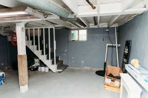 Below grade area with stairs and drainage system