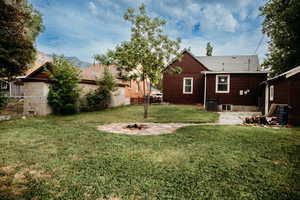 Rear view of house featuring a patio, an outdoor fire pit, a fenced backyard