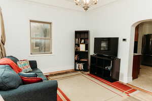 Living area with arched walkways, crown molding