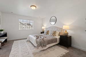 Primary bedroom featuring carpet flooring, light paint and large window