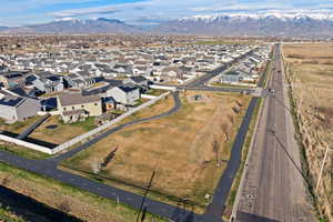 Aerial view of Stillwater Community featuring walking paths and a mountain backdrop