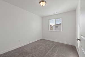 Second floor spare bedroom featuring carpet floors and light paint