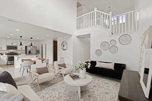 Open concept main floor featuring a living room flowing through to the dining space and kitchen