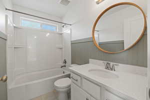 Second floor full bathroom featuring wainscotting, decorative mirror, tub/shower combo, and vanity with quartz countertops