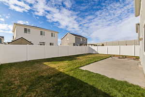 Fully fenced backyard with patio and raised garden beds