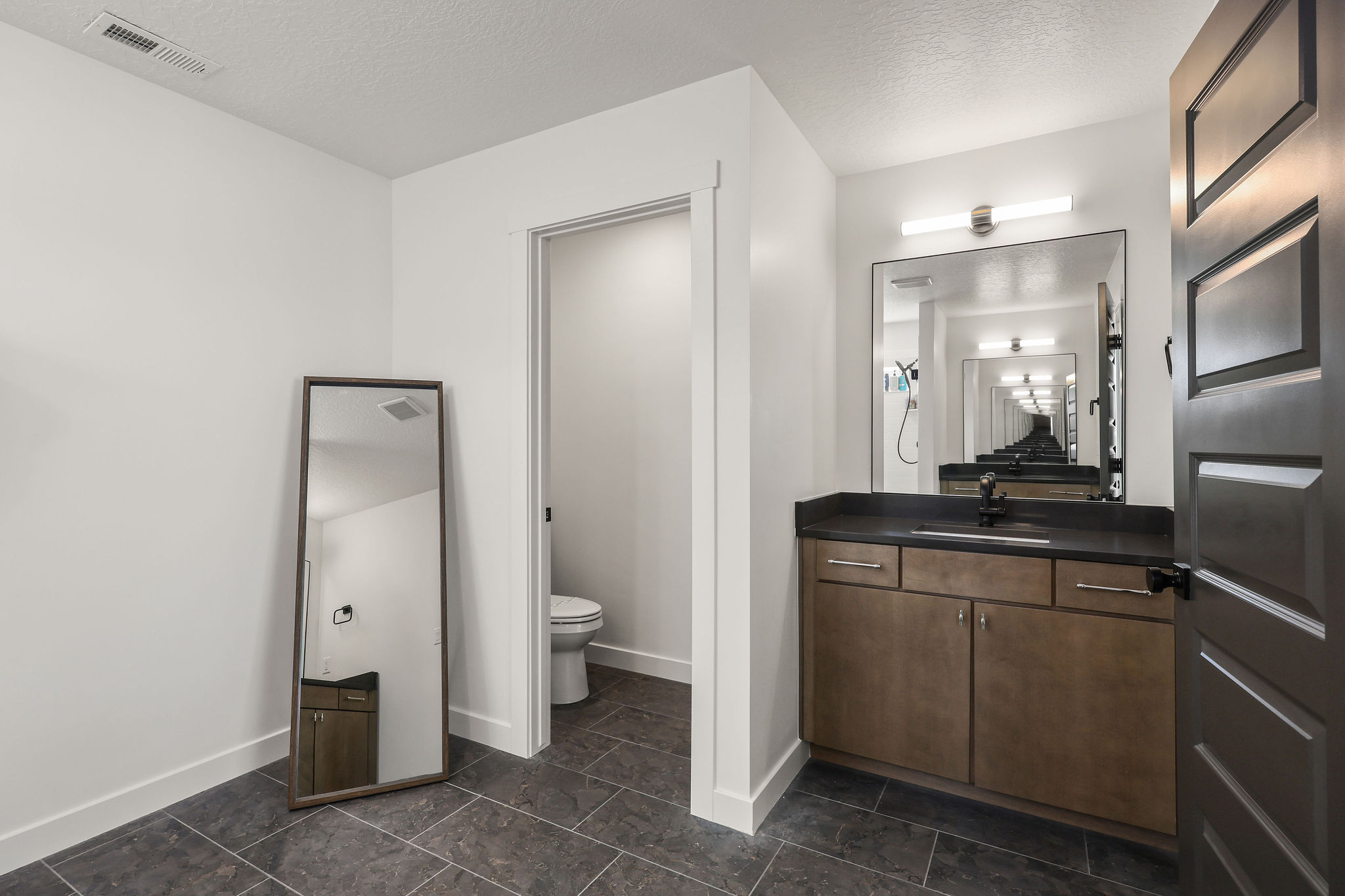 Full bathroom with vanity and a textured ceiling
