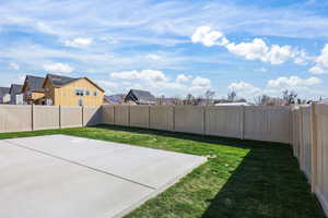Fenced backyard featuring a residential view and a patio