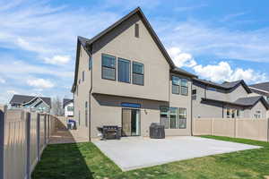 Back of house featuring a fenced backyard, stucco siding, and a patio