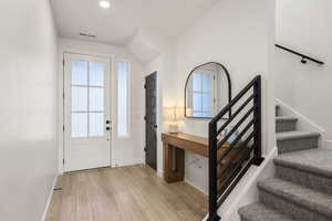 Entrance foyer with light wood-style floors and healthy amount of natural light