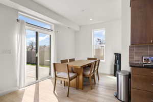 Dining room with light wood finished floors and baseboards
