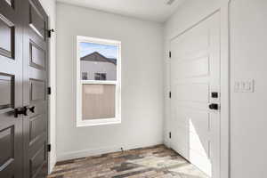 Foyer entrance with baseboards and light wood-style floors