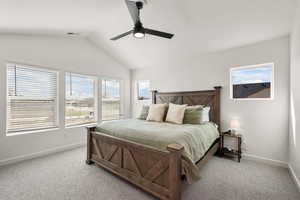 Bedroom featuring vaulted ceiling, ceiling fan, and light carpet