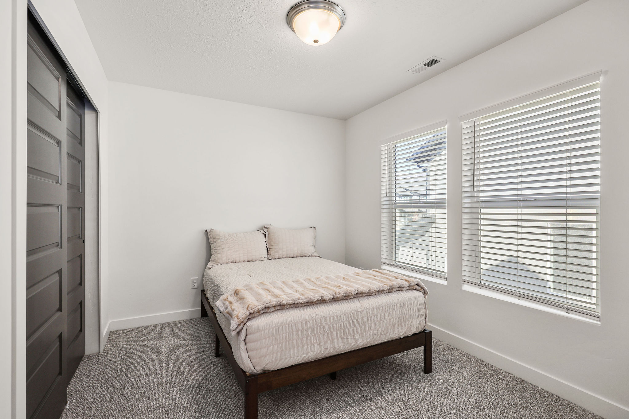 Carpeted bedroom with baseboards and a closet
