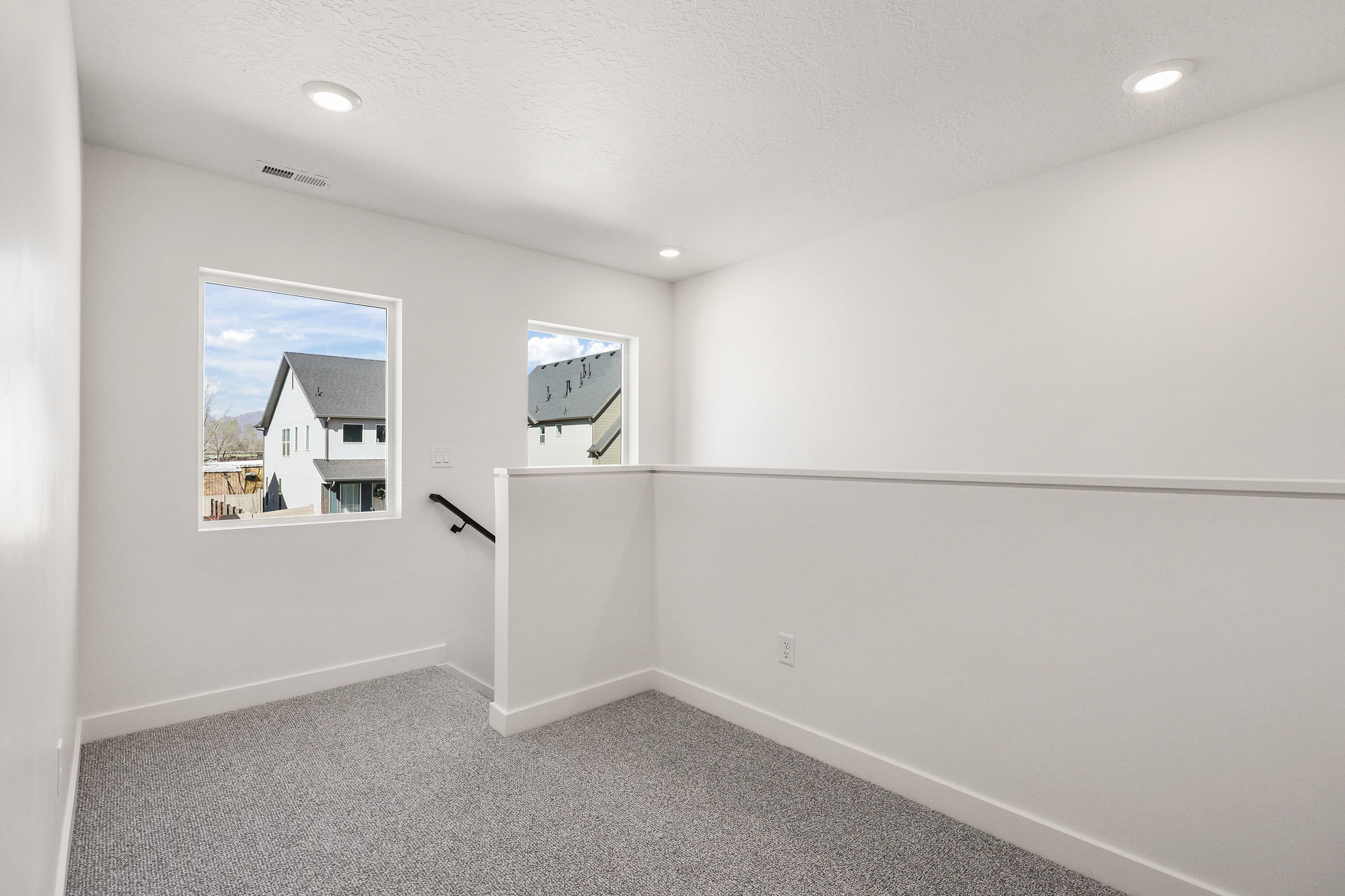 Unfurnished room featuring light carpet, recessed lighting, and a textured ceiling