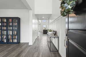 Foyer entrance with dark wood-style floors and recessed lighting