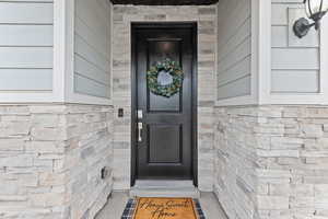 Entrance to property with stone siding