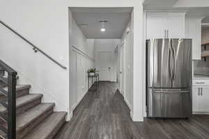 Corridor featuring dark wood finished floors and recessed lighting