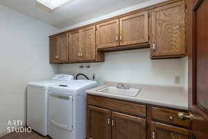 Laundry room featuring cabinet space and independent washer and dryer
