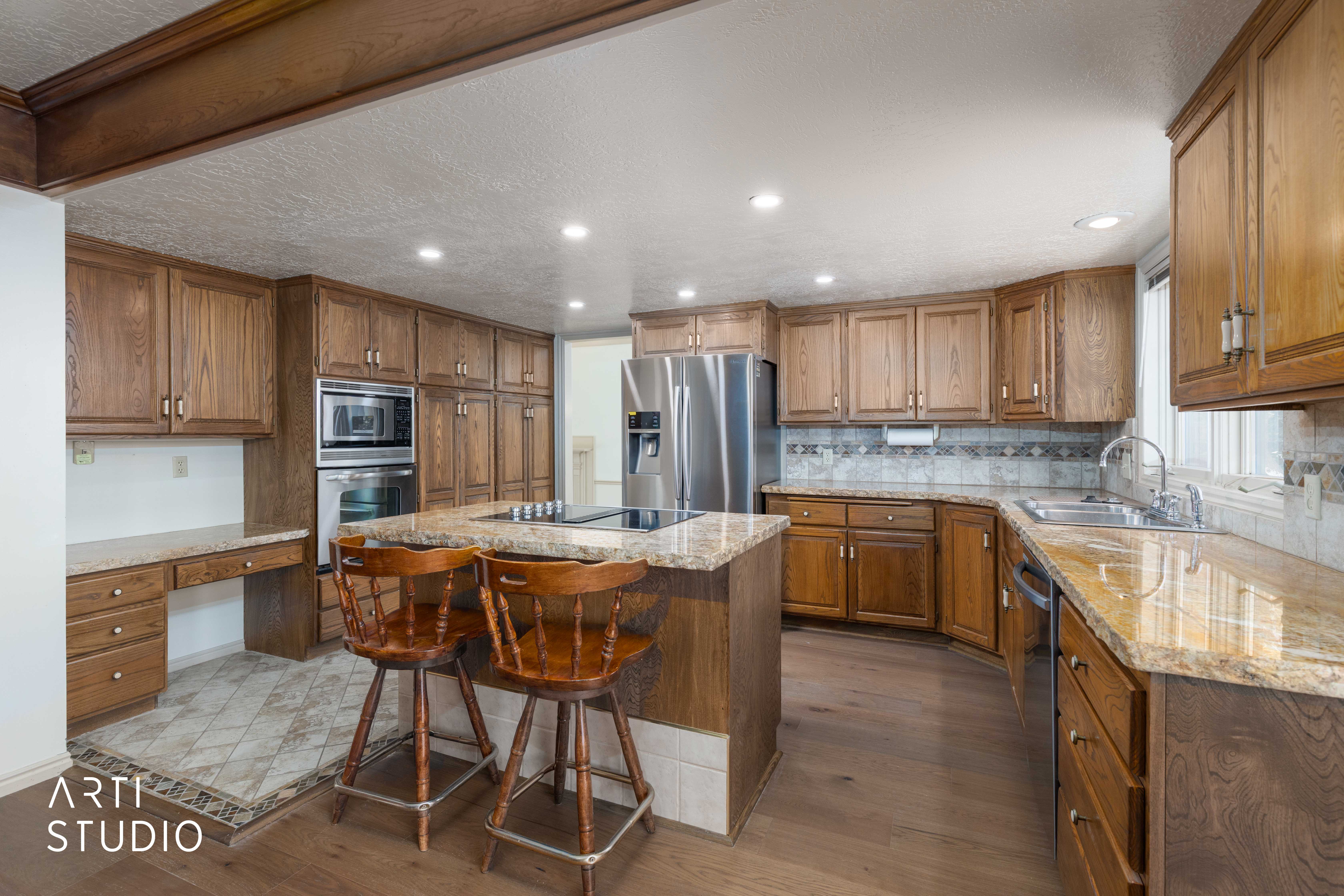 Kitchen featuring a center island, a kitchen breakfast bar, dark wood-style flooring, wood finish cabinets, and recessed lighting
