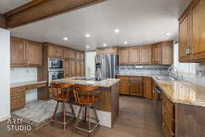 Kitchen featuring a center island, a kitchen breakfast bar, dark wood-style flooring, wood finish cabinets, and recessed lighting