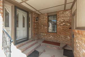 Doorway to property with brick siding