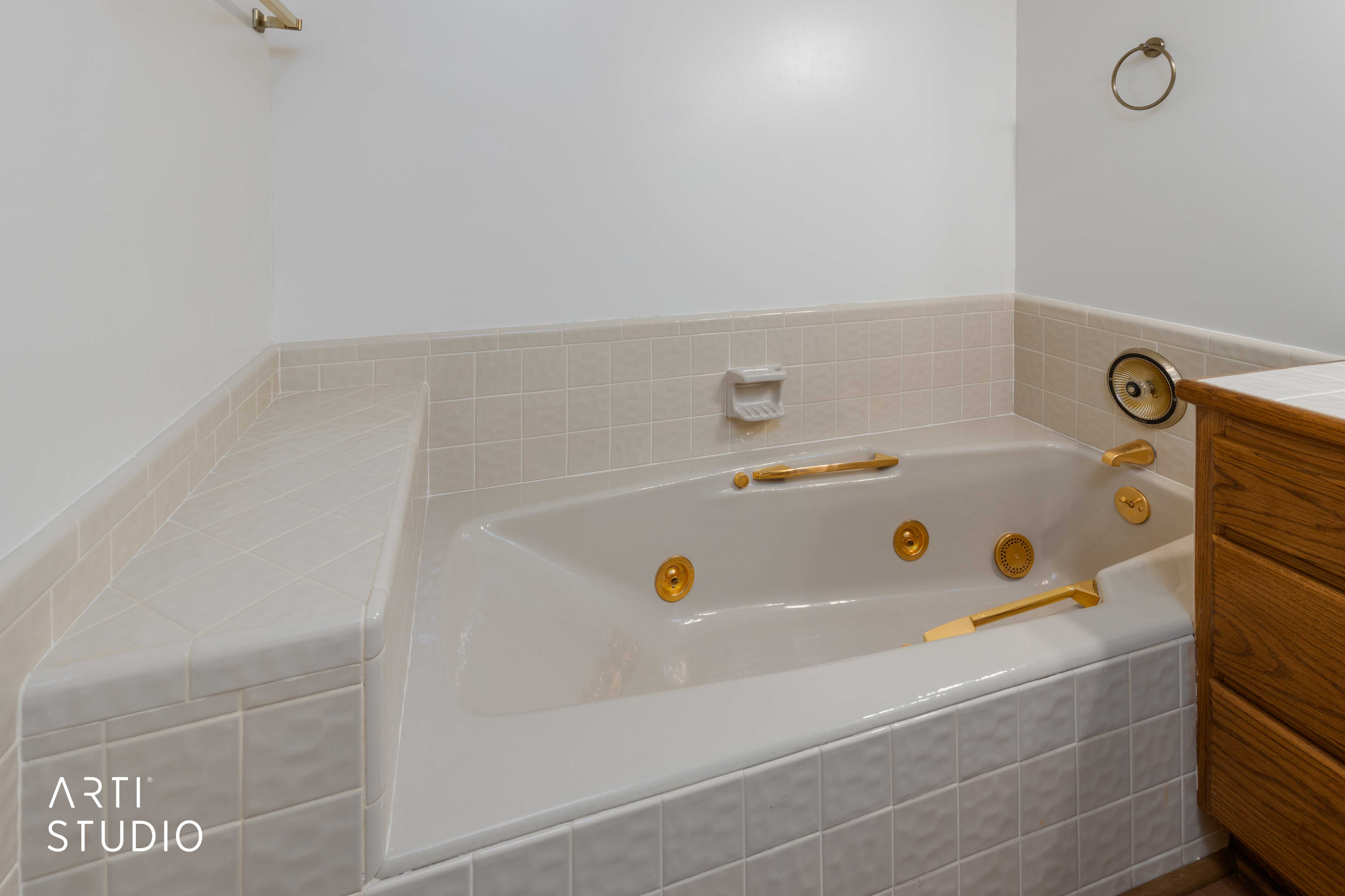 Full bath with a jetted tub and vanity