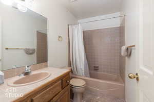 Full bathroom with vanity, a textured ceiling, and shower / tub combo