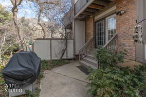 Property entrance featuring brick siding