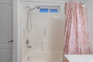 Full bathroom with shower / bathtub combination with curtain