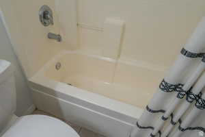 Bathroom with toilet and light tile patterned floors