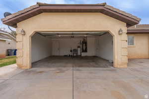 Garage with concrete driveway and secured water heater