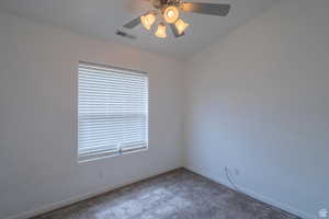 Empty room with carpet floors and ceiling fan
