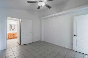 Unfurnished room with a ceiling fan and light tile patterned floors