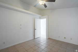 Unfurnished room featuring a ceiling fan and light tile patterned floors