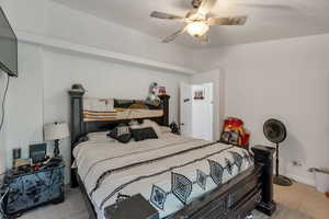 Bedroom with light tile patterned floors and ceiling fan