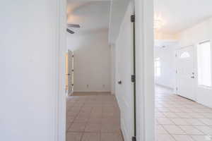 Hallway featuring light tile patterned floors