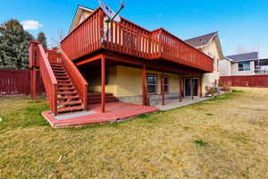 Back of house with a wooden deck and stairs
