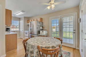 Dining space featuring light wood-type flooring and a ceiling fan
