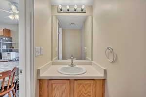 Bathroom featuring vanity and a ceiling fan