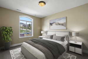 Bedroom with dark carpet and baseboards