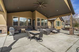 View of patio featuring an outdoor living / dining area, a ceiling fan, and a grill