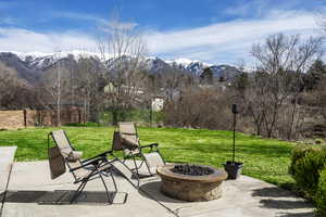 View of patio / terrace featuring an outdoor fire pit and a mountain view