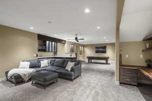 Living room with wet bar, carpet flooring, billiards table, recessed lighting, and a ceiling fan