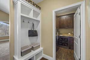 Mudroom with wood finish floors and washer / clothes dryer
