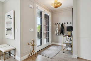 Doorway to outside with wood finished floors and baseboards
