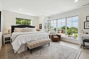 Bedroom with light wood finished floors and recessed lighting