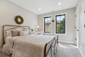 Bedroom featuring light carpet and recessed lighting