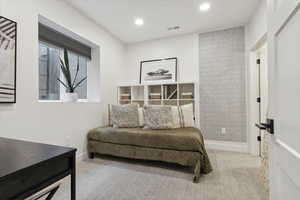 Bedroom featuring light carpet and recessed lighting