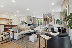 Living area featuring light wood-style flooring and recessed lighting